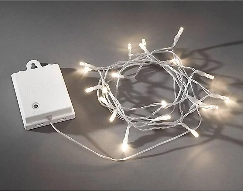Besuche den Konstsmide-Store Konstsmide LED Lichterkette, mit an, aus Schalter, Lichtsensor, 6h und 9h Timer, 20 warm weiße Dioden, batteriebetrieben, Außen (IP44), transparentes Kabel, weiße Box, 4 x AA 1.5V (exkl.) - 3722-103 — Weihnachtsbeleuchtung